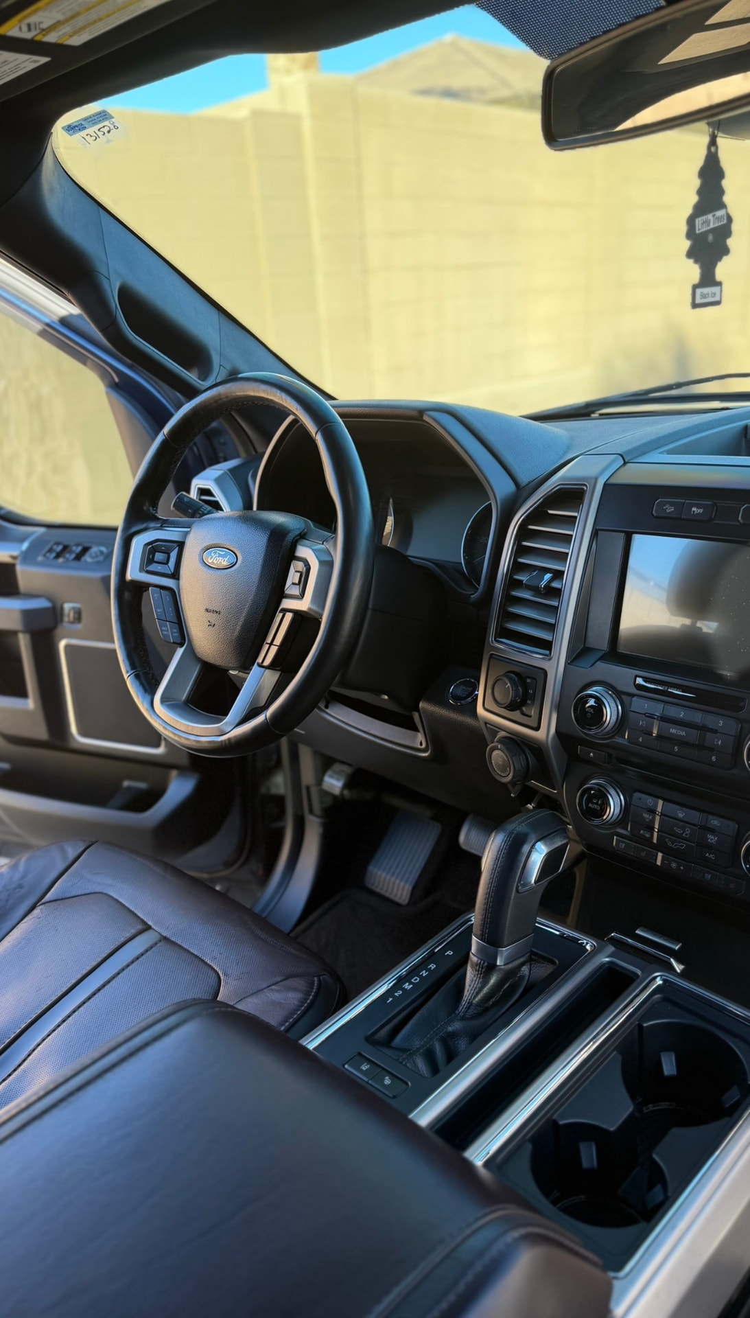 Clean Ford F-150 interior with detailed dash, console and leather seats