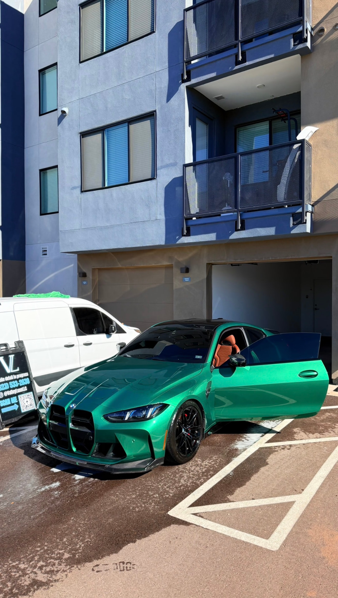 Green BMW M4 detailed on site with the mobile detailing setup nearby
