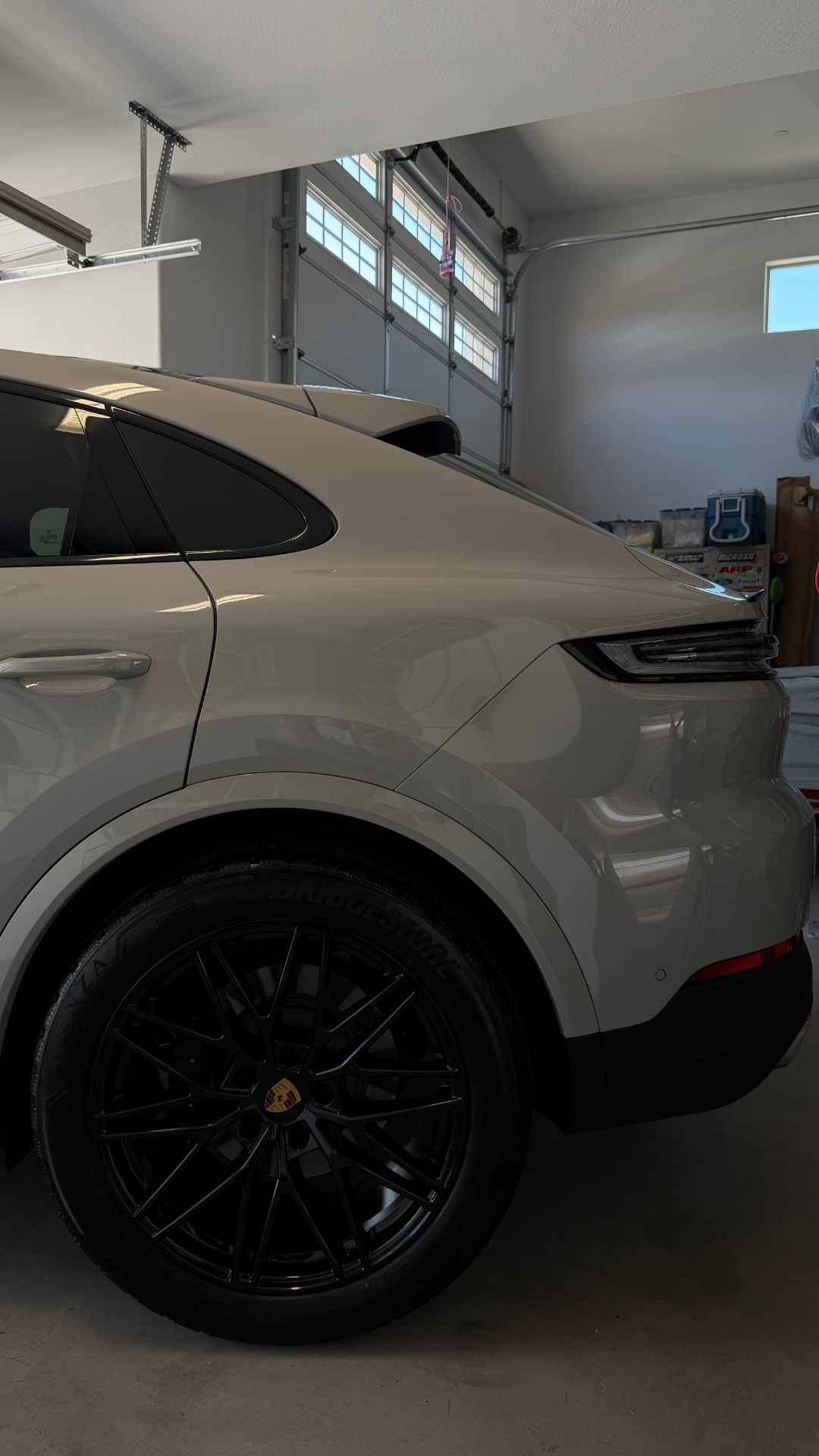 Porsche Cayenne Coupe with a glossy finish after detailing in a garage